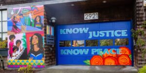 A colorful street mural on the offices of East Bay Community Law Center with the motto "Know Justice, Know Peace."