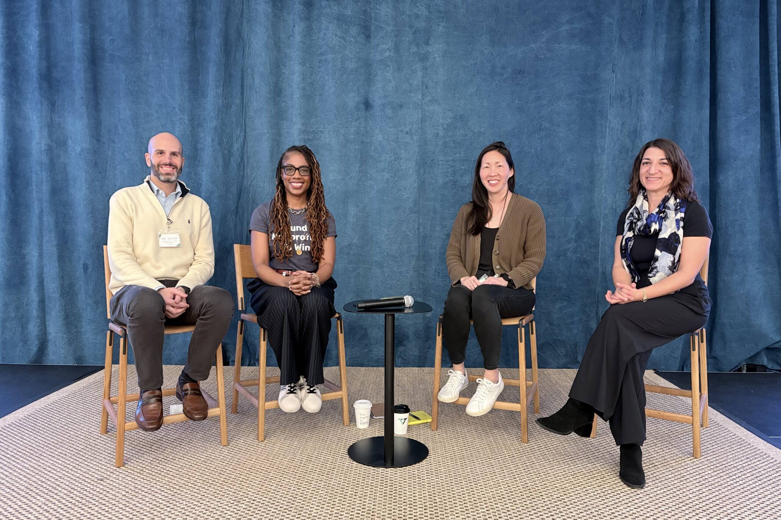 Four foundation executives sit as panelists on a stage