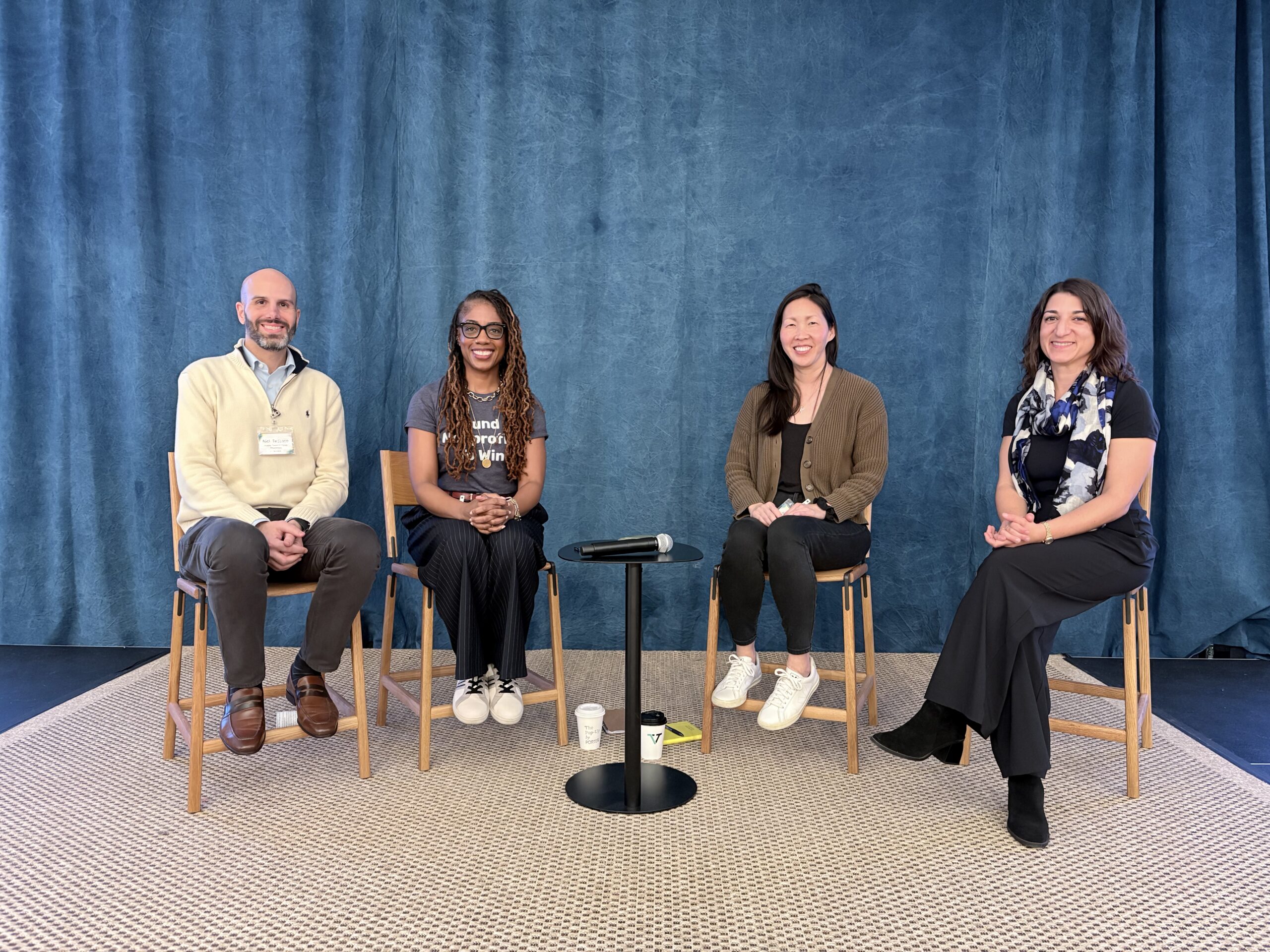 Four foundation executives sit as panelists on a stage